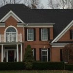 White Seamless Gutters & Downspouts with Black Gutter Topper