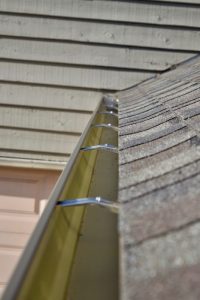 Inside Seamless Gutter Hangers Install by Dennison Exterior Solutions & Gutter Topper