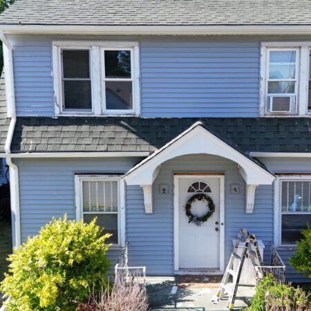 Front of a South Bend, IN home with new Oxford Blue vinyl siding, white soffit and fascia, and seamless gutters