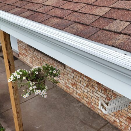 White Solution gutter guards on new seamless gutters over the front porch in St. Joseph, MI