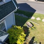 Charcoal Solution gutter guard and white downspout on a South Bend, IN home