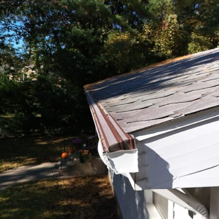 Corner of a new seamless gutter and white aluminum fascia in Benton Harbor, MI