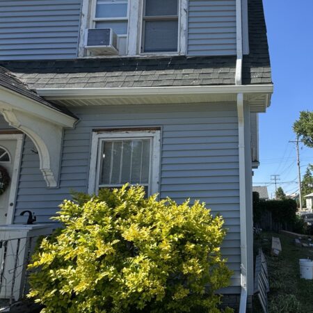 Side of a South Bend, IN home with new vinyl siding, soffit, fascia and downspout
