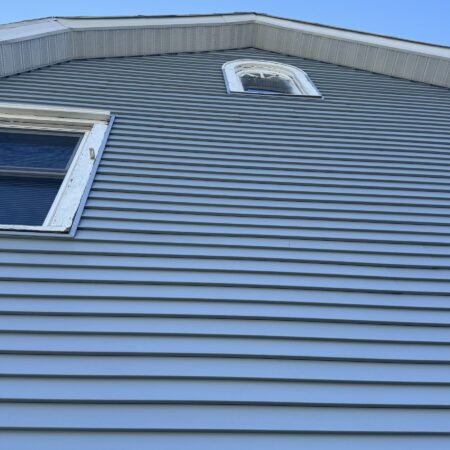 Upper gable with new vinyl siding and white aluminum fascia in South Bend, IN