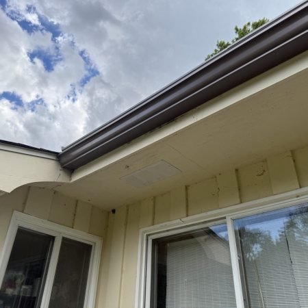 New Light Bronze seamless gutter and soffit vent on a Berrien Springs, MI home