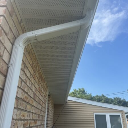 Vented soffit and White downspout on a St. Joseph, MI home