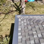 Hip corner detail with Georgetown Gray hip caps and Charcoal Gutter Topper wrapping the eaves
