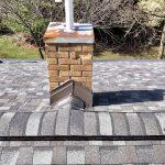 Chimney with a new flashing kit next to CertainTeed ridge vent and Georgetown Gray ridge caps