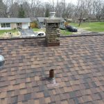 Chimney with new saddle and flashing and a re-flashed round skylight on a Coloma, MI roof