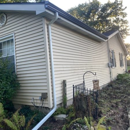 New white downspout on black seamless gutters at a Hobart, IN home