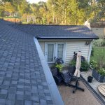 Hobart IN Gutters 06 Black Gutter Topper installed on new seamless gutters above a patio in Hobart, IN