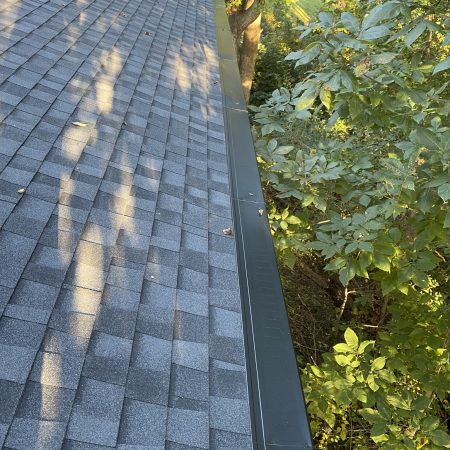 Gutter Topper protecting new seamless gutters under tree cover in Hobart, IN