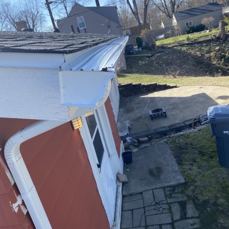 New White seamless gutter end cap and downspout with Solution gutter protection in St. Joseph, MI