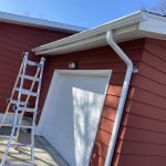 St Joseph MI Gutters Solution 04 New 5" White seamless gutter and 2x3 downspout over the garage of a St. Joseph, MI home