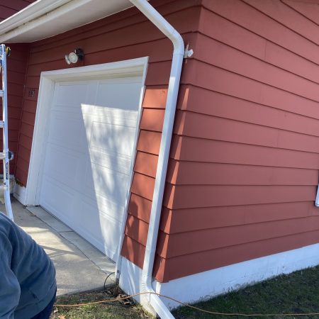New White seamless gutter and downspout at the garage corner in St. Joseph, MI