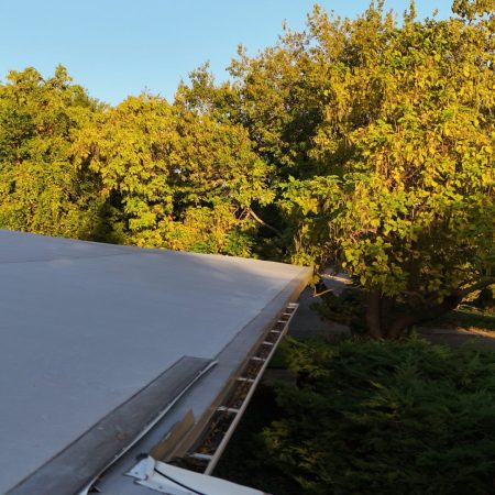 Tan Gutter Topper along the roof edge of a St. Joseph, MI home in the fall