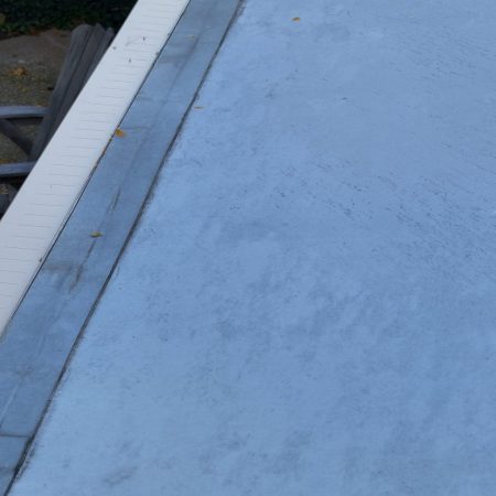Gutter Topper on Buckskin seamless gutter at a low-slope roof in St. Joseph, MI