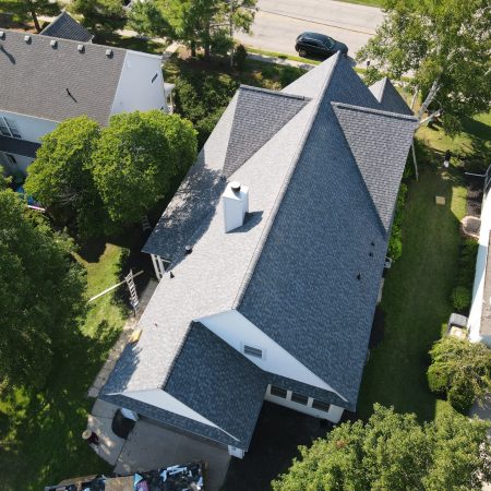 Aerial view of the completed Pewter roof replacement in St. Joseph, MI showing the ridge lines and chimney