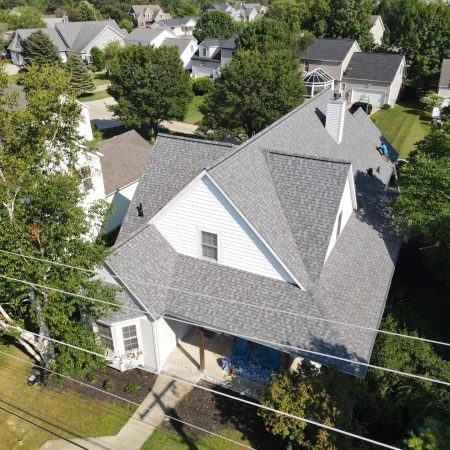 Drone view of the new CertainTeed NorthGate Pewter roof on a St. Joseph, MI home among mature trees