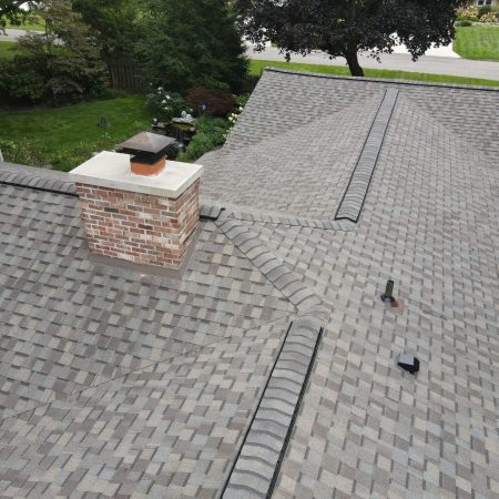 Chimney flashing, ridge vent and hip caps on roof replacement in Stevensville, MI