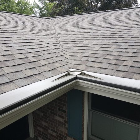 Gutter Topper in Light Bronze on seamless Almond gutters in Stevensville, MI