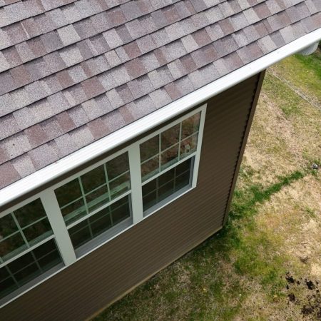 White Solution Cover gutter protection along the eave of a Valparaiso, IN home with brown siding